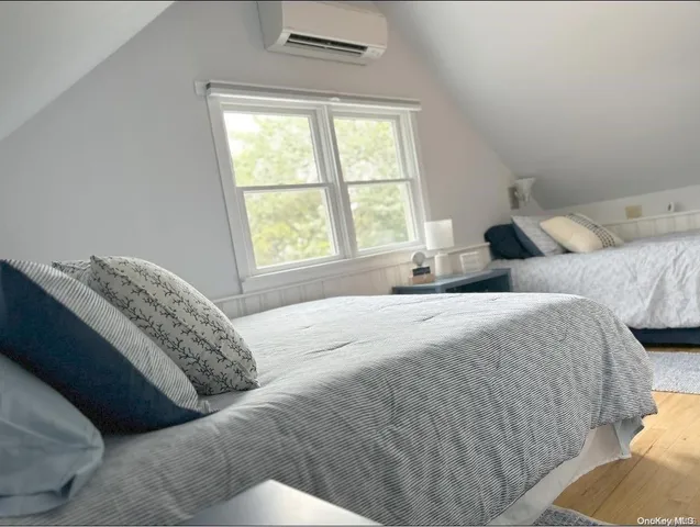 a bed sitting in a bedroom next to a window