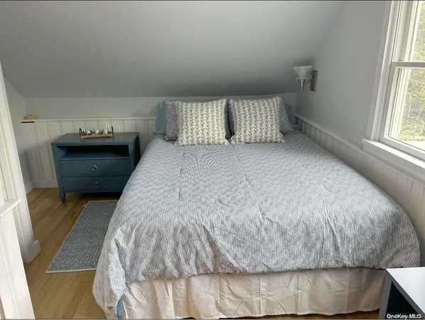 a bed sitting in a bedroom next to a window