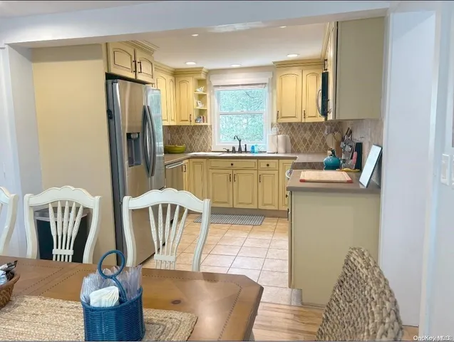 a kitchen with stainless steel appliances granite countertop a refrigerator and a sink