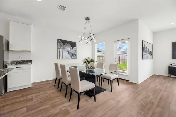 a view of a dining room with furniture window and wooden floor