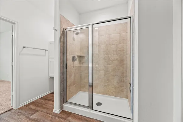 a bathroom with a glass shower door