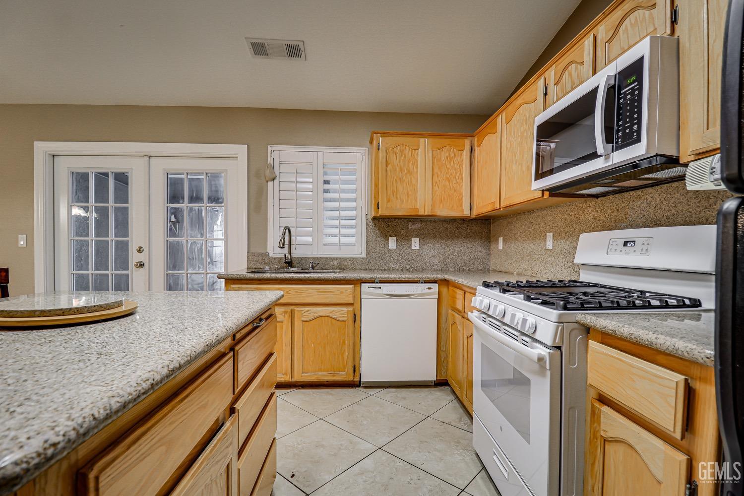 Undisclosed Address Bakersfield, CA 93312 - Photo 11 of 28 a kitchen with granite countertop cabinets stainless steel appliances and a sink