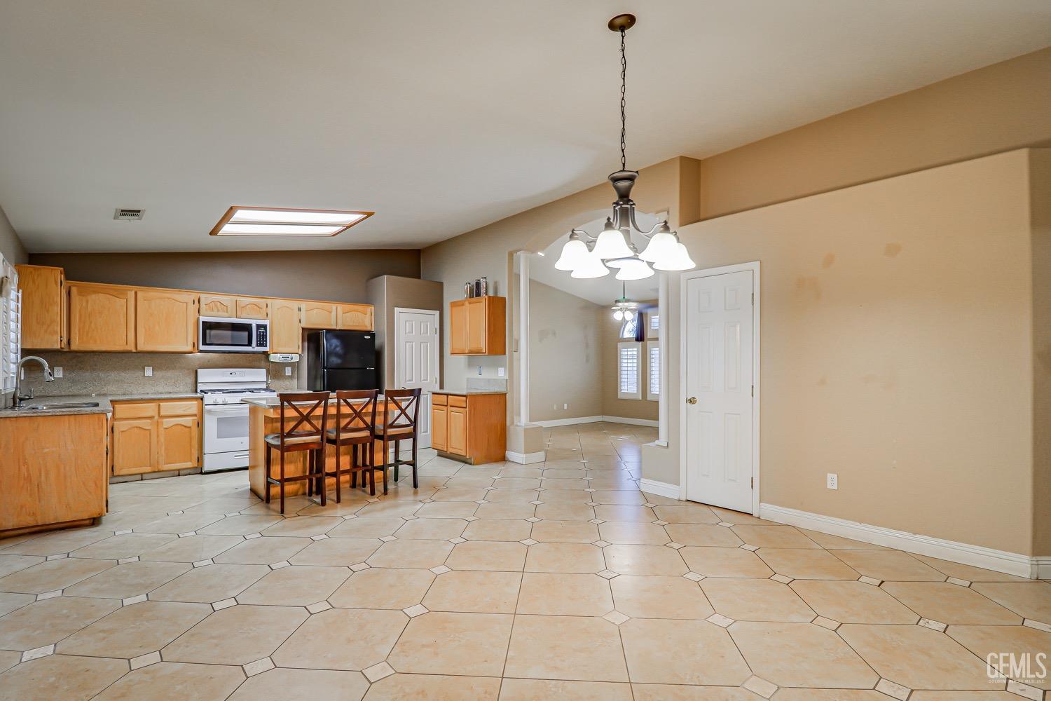 Undisclosed Address Bakersfield, CA 93312 - Photo 13 of 28 a view of a kitchen with granite countertop cabinets and refrigerator