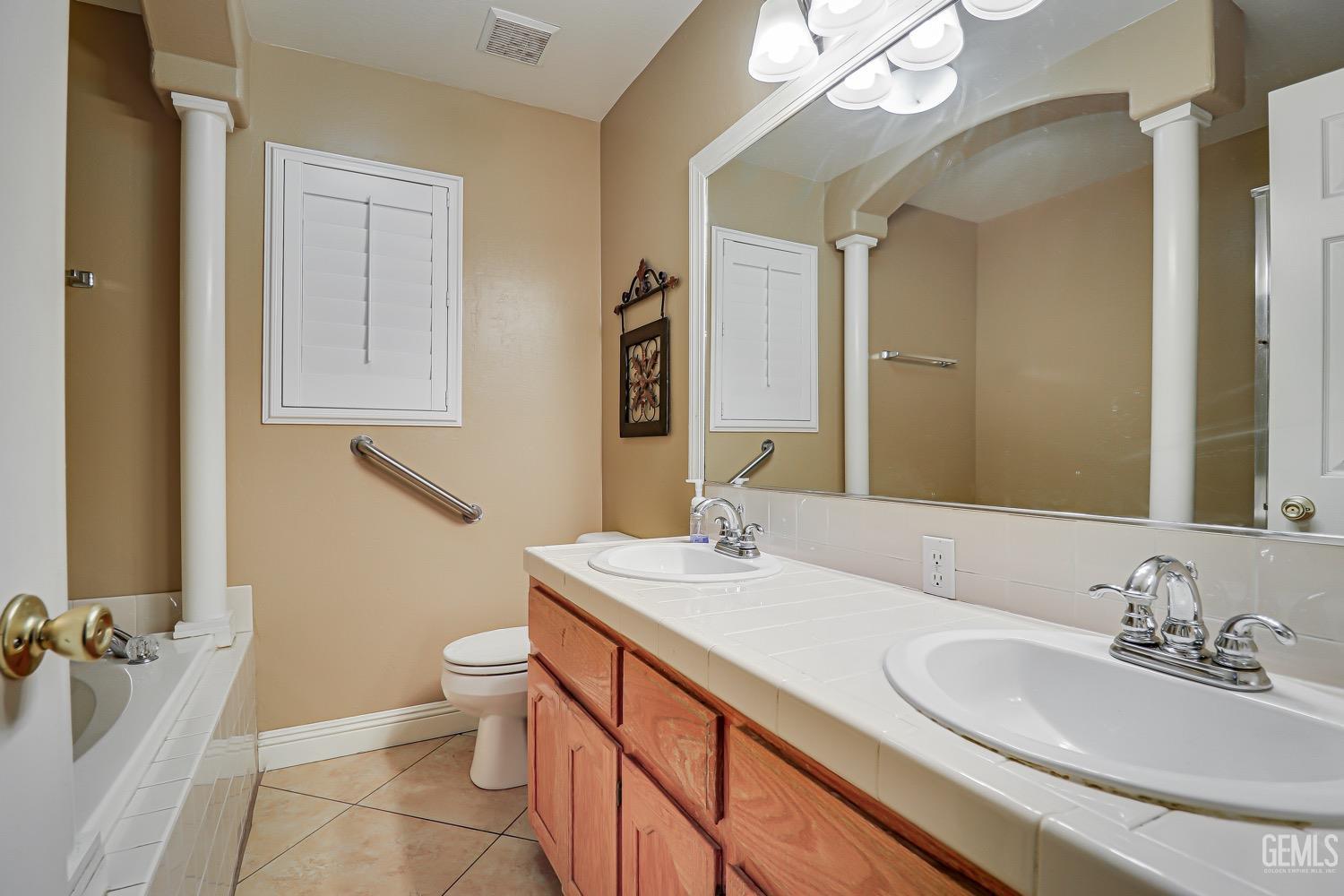 Undisclosed Address Bakersfield, CA 93312 - Photo 20 of 28 a bathroom with a granite countertop sink mirror and toilet