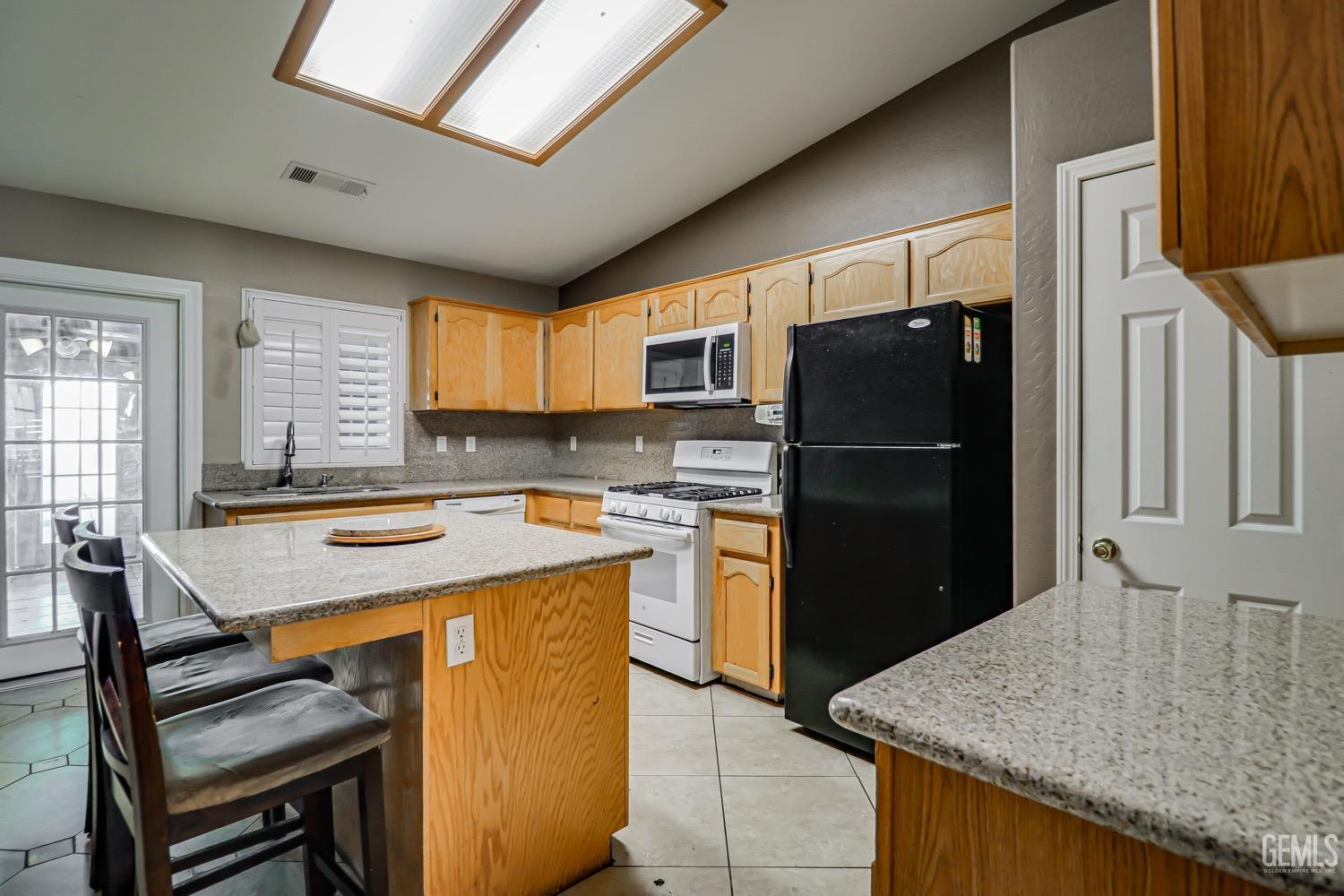 Undisclosed Address Bakersfield, CA 93312 - Photo 8 of 28 a kitchen with a stove a refrigerator and a sink