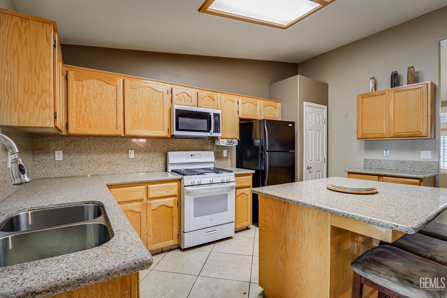 Undisclosed Address Bakersfield, CA 93312 - Photo 10 of 28 a kitchen with stainless steel appliances granite countertop a sink stove and refrigerator