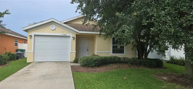 a front view of house with yard and trees