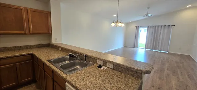 a kitchen with a sink a counter top space and cabinets