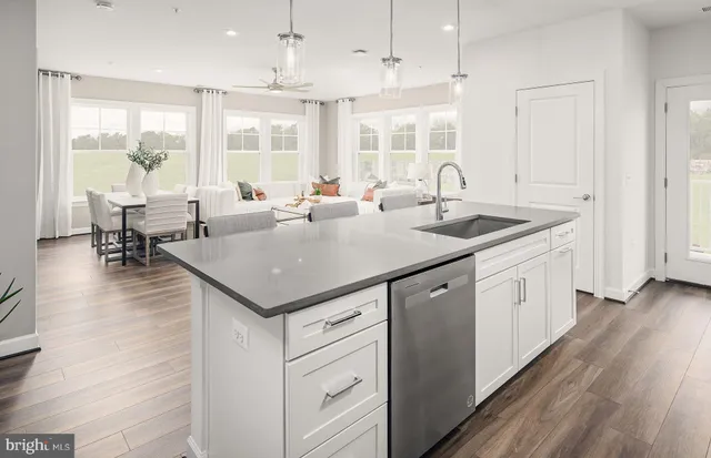 a kitchen with a stove center island wooden floor and a window