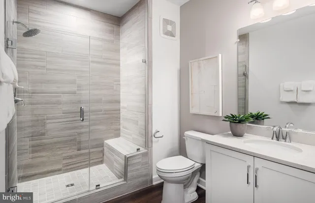 a large bed sitting in a bedroom next to a window