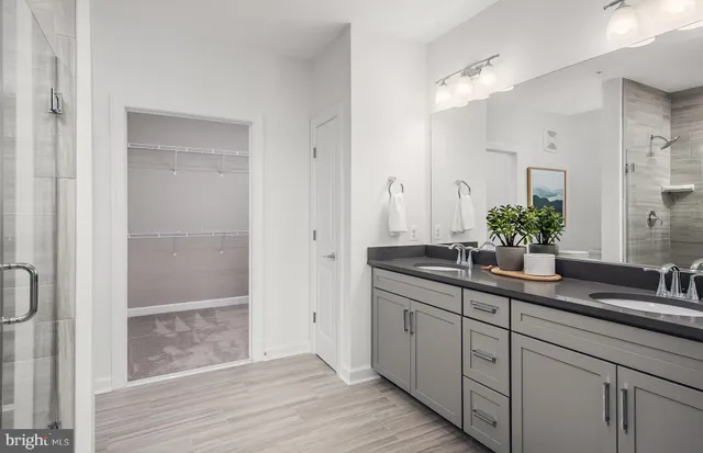 a bedroom with a large bed and a chandelier fan