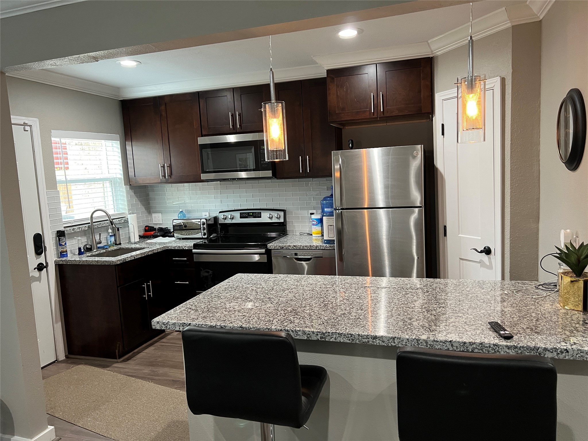 1909 Ruth Street Houston, TX 77004 - Photo 24 of 35 a kitchen with stainless steel appliances granite countertop a refrigerator a sink a stove a microwave and wooden cabinets
