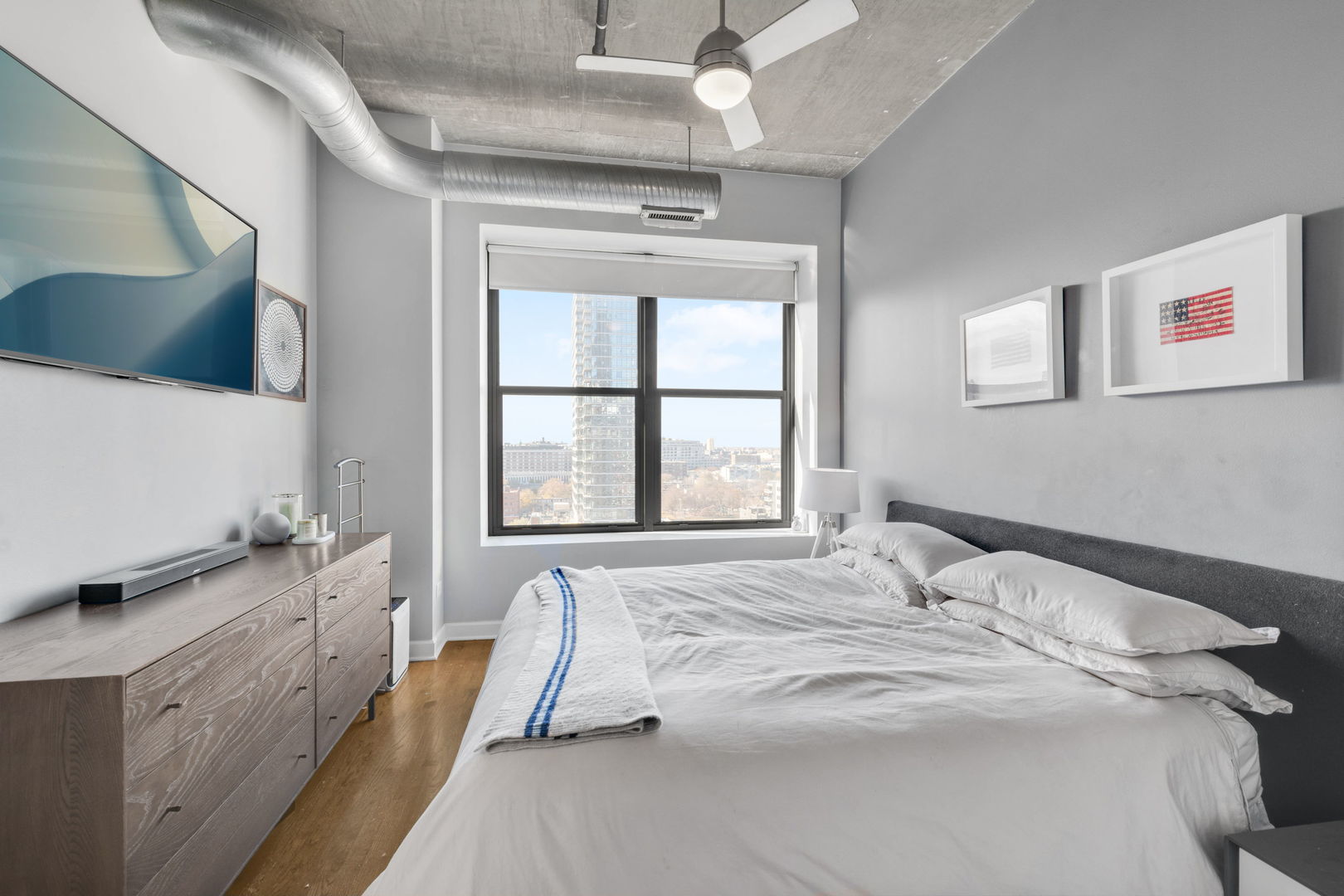 849 North Franklin Street, Unit 1201 Chicago, IL 60610 - Photo 12 of 40 a spacious bedroom with a bed and a large window