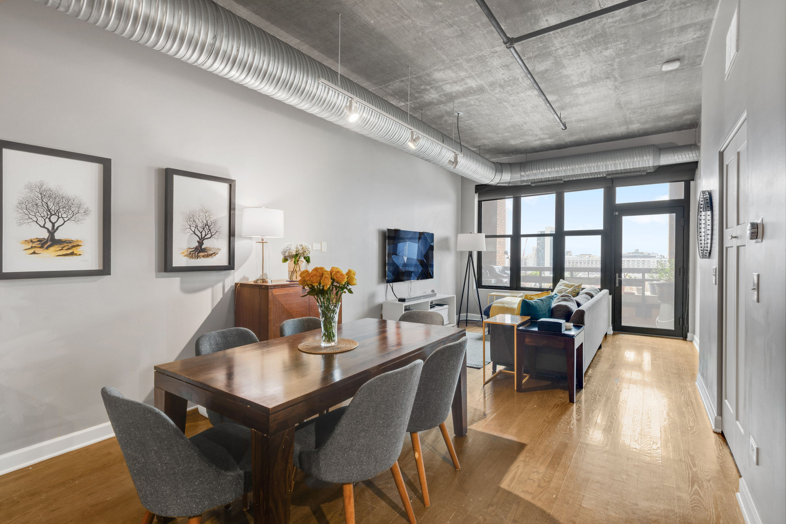 849 North Franklin Street, Unit 1201 Chicago, IL 60610 - Photo 4 of 40 a dining room with furniture a couch and a chandelier