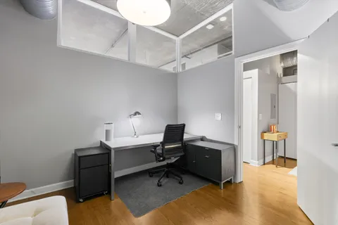 a view of a workspace with furniture