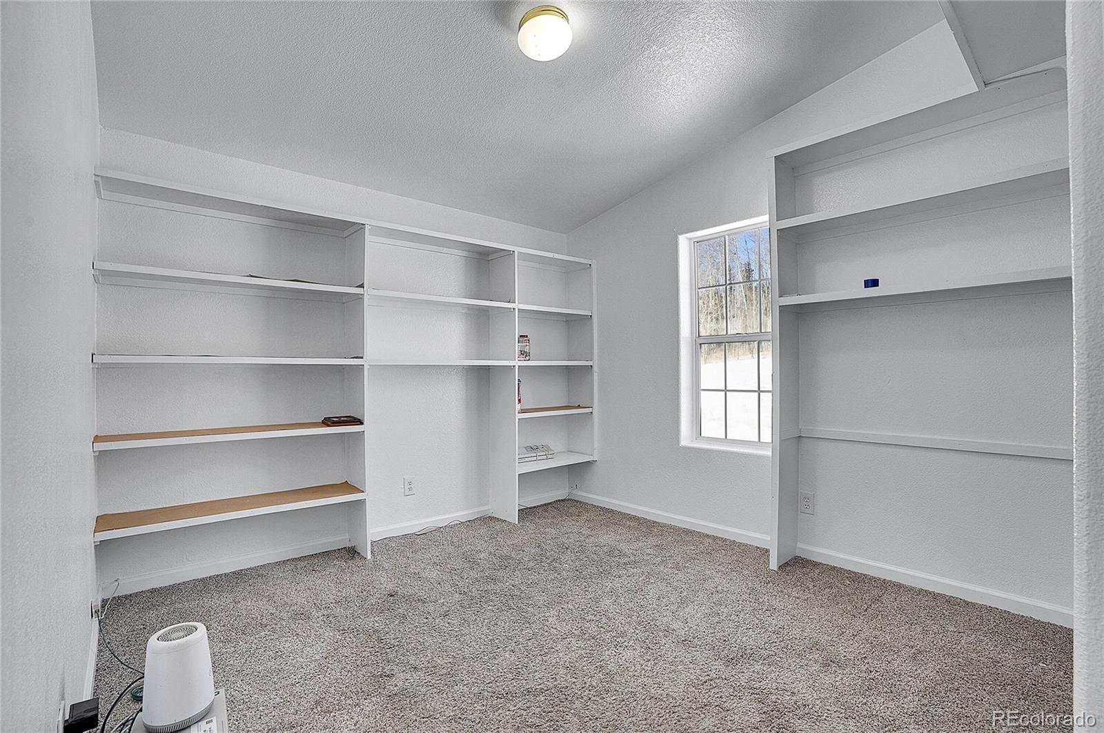 280 Apache Trail Jefferson, CO 80456 - Photo 14 of 50 a view of an empty room with a window