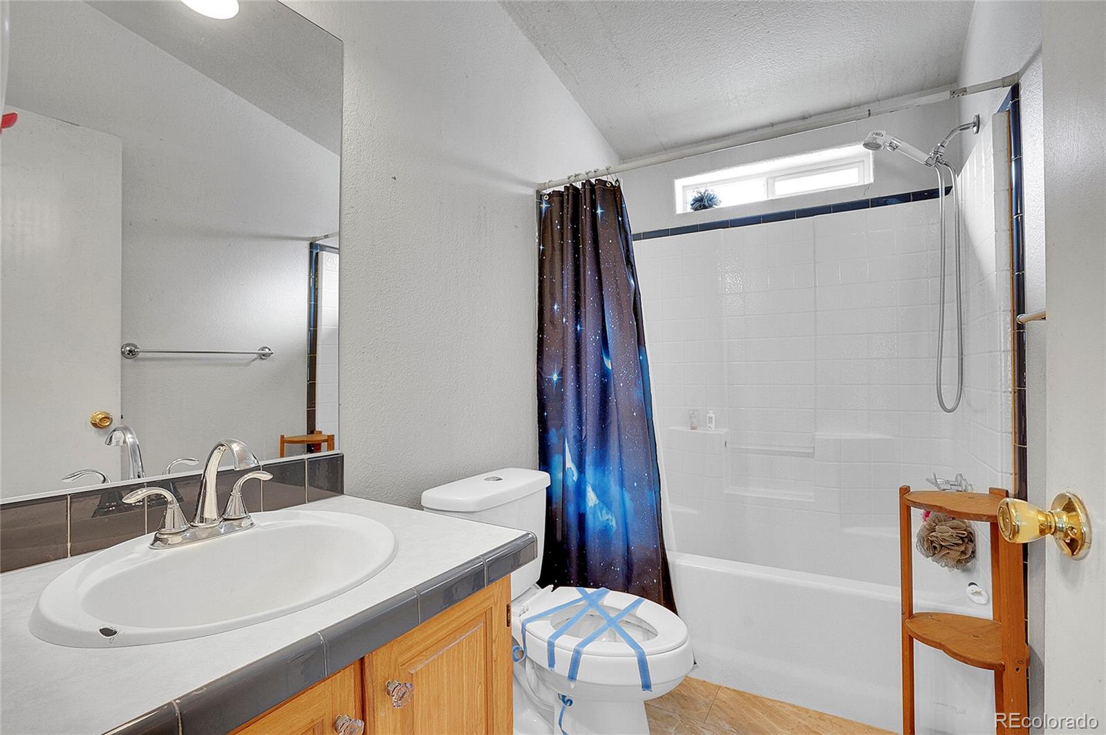 280 Apache Trail Jefferson, CO 80456 - Photo 15 of 50 a bathroom with a sink toilet and shower