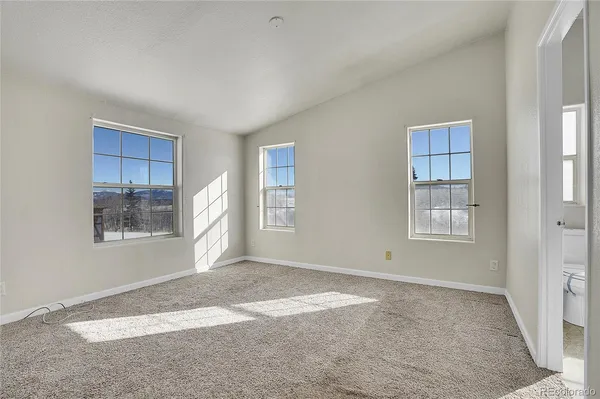a view of an empty room with windows