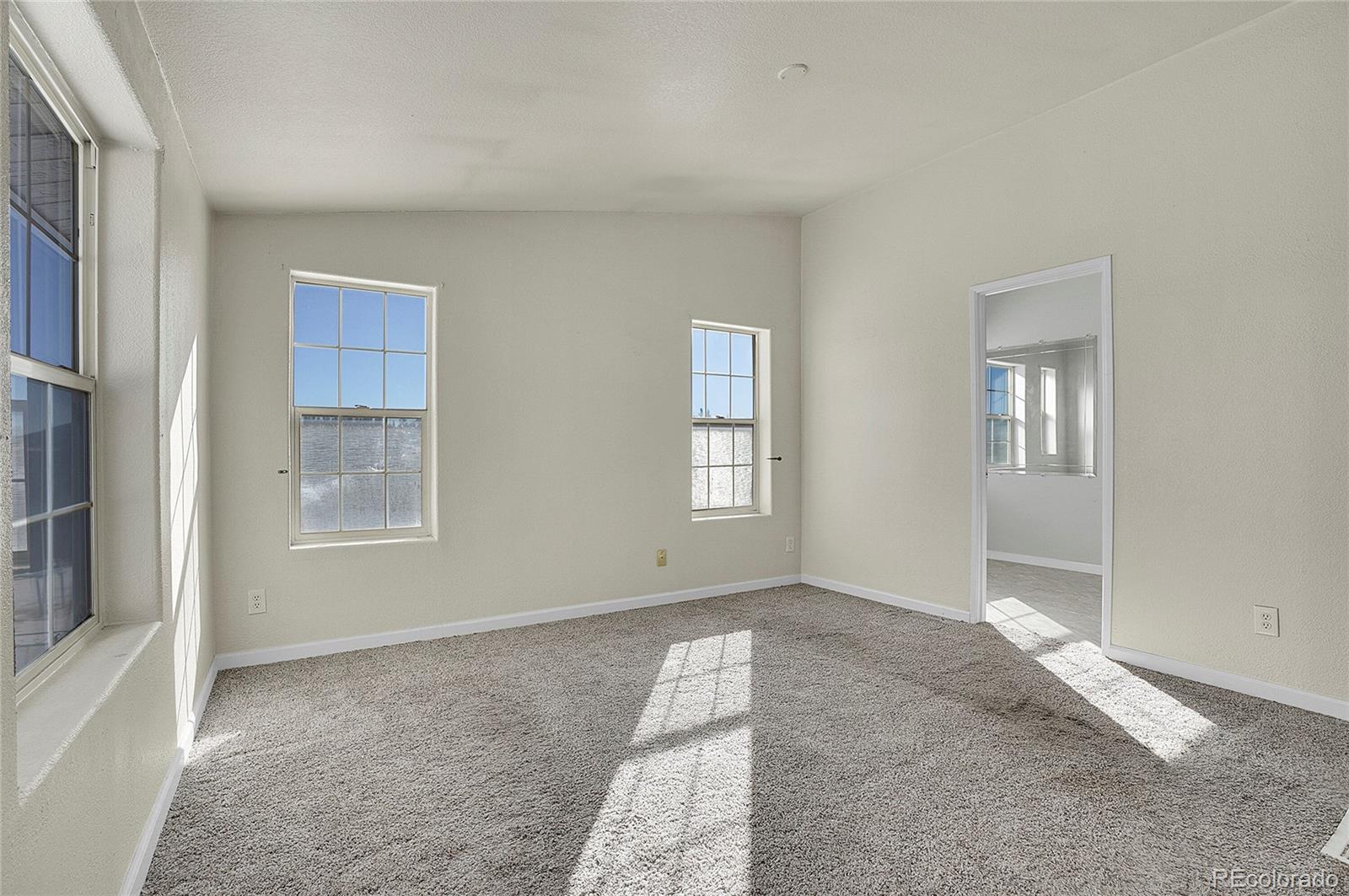 280 Apache Trail Jefferson, CO 80456 - Photo 17 of 50 a view of an empty room with windows