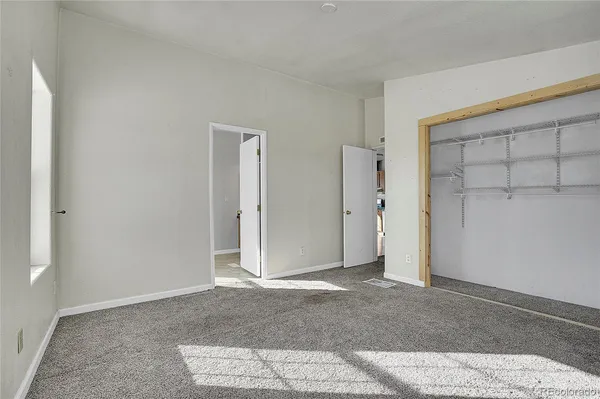 a bathroom with a toilet and a view of bathroom