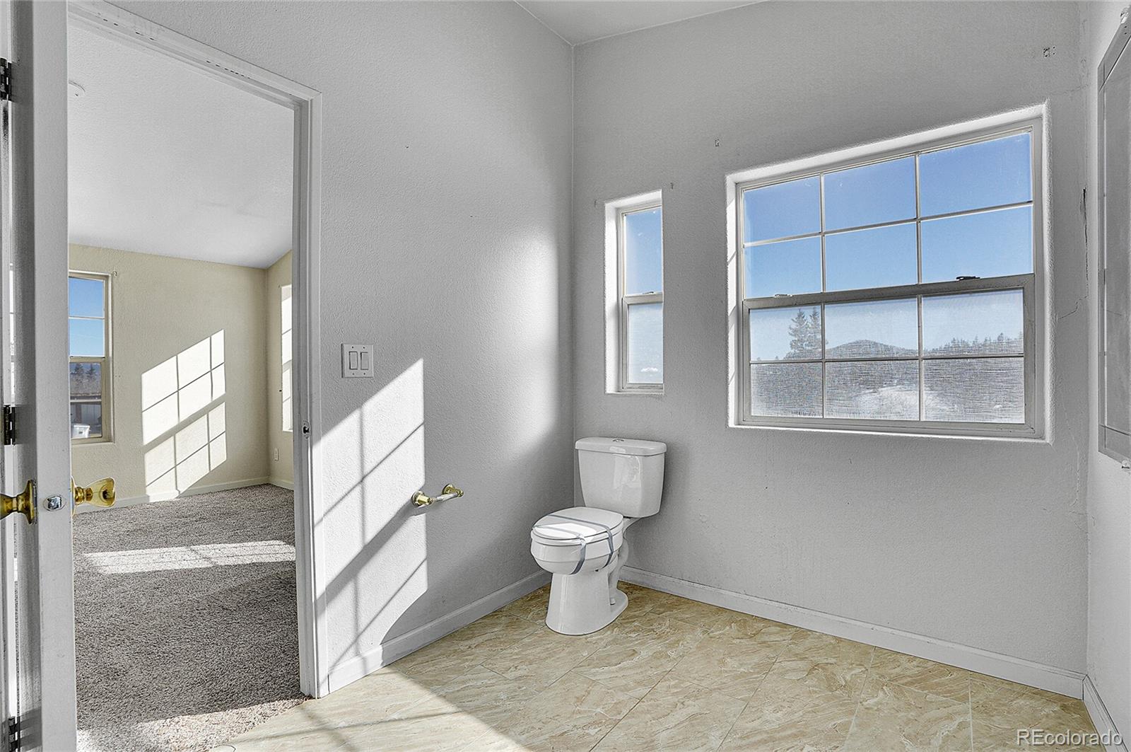280 Apache Trail Jefferson, CO 80456 - Photo 21 of 50 a bathroom with a toilet and a view of bathroom