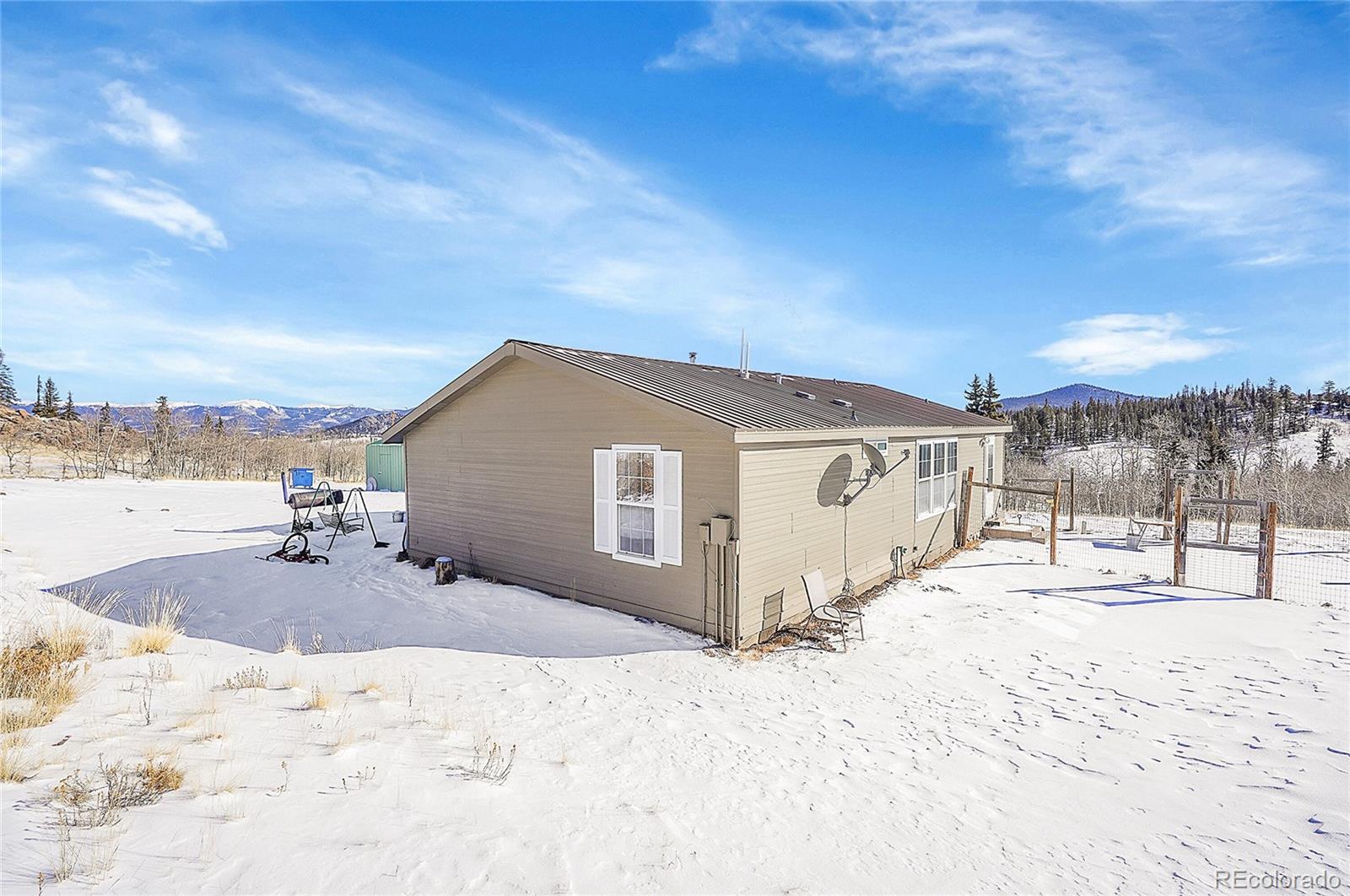 280 Apache Trail Jefferson, CO 80456 - Photo 26 of 50 a view of a backyard of snow