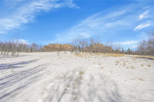 a swimming pool with outdoor seating and mountain view