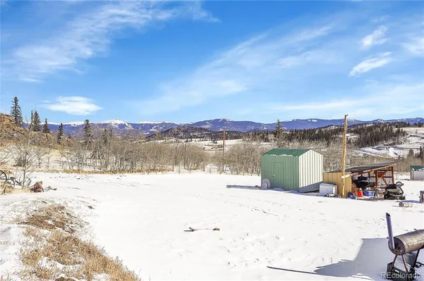 a view of a house with a yard covered in snow