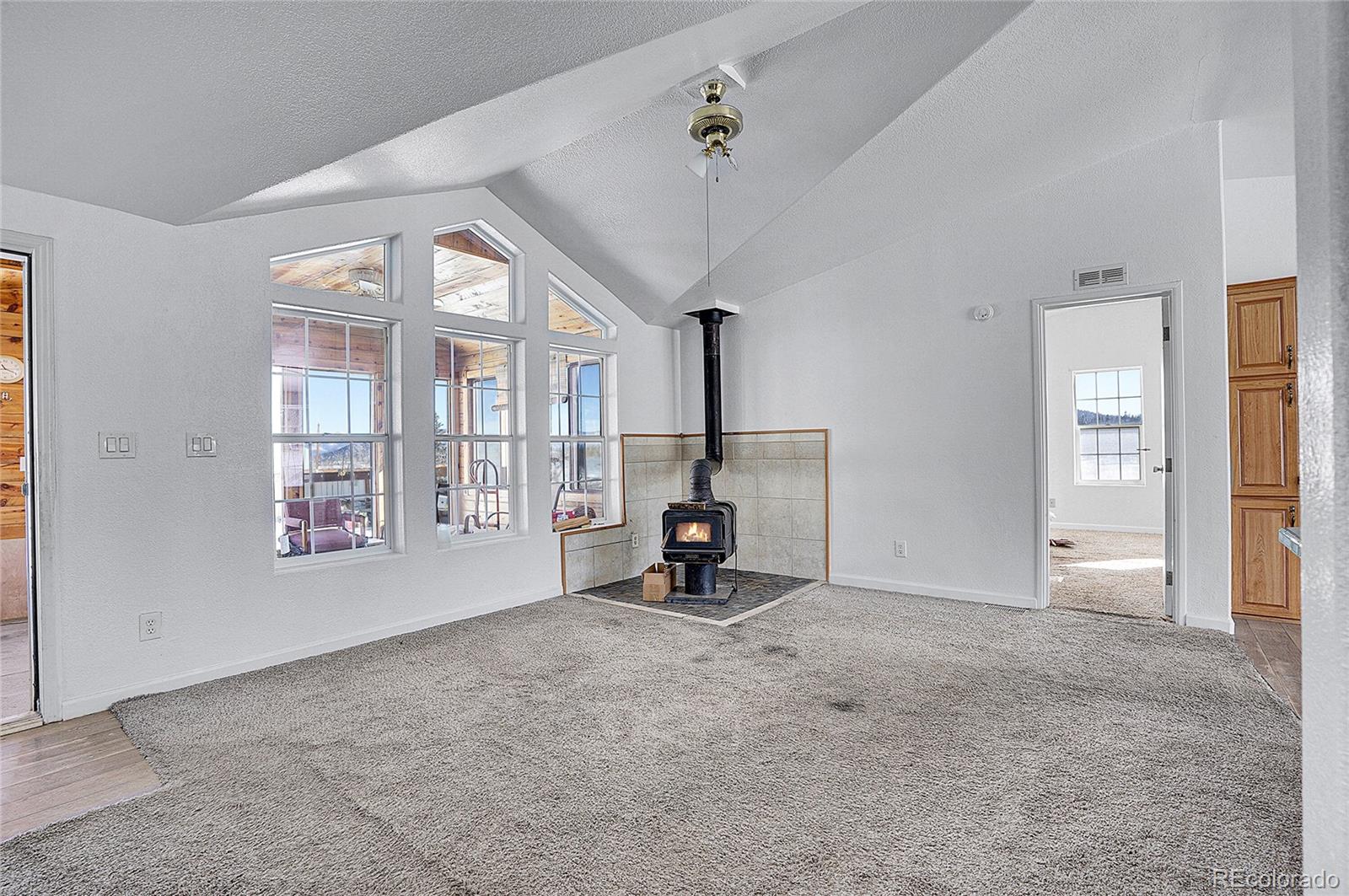 280 Apache Trail Jefferson, CO 80456 - Photo 6 of 50 a view of an empty room with a fireplace and a window