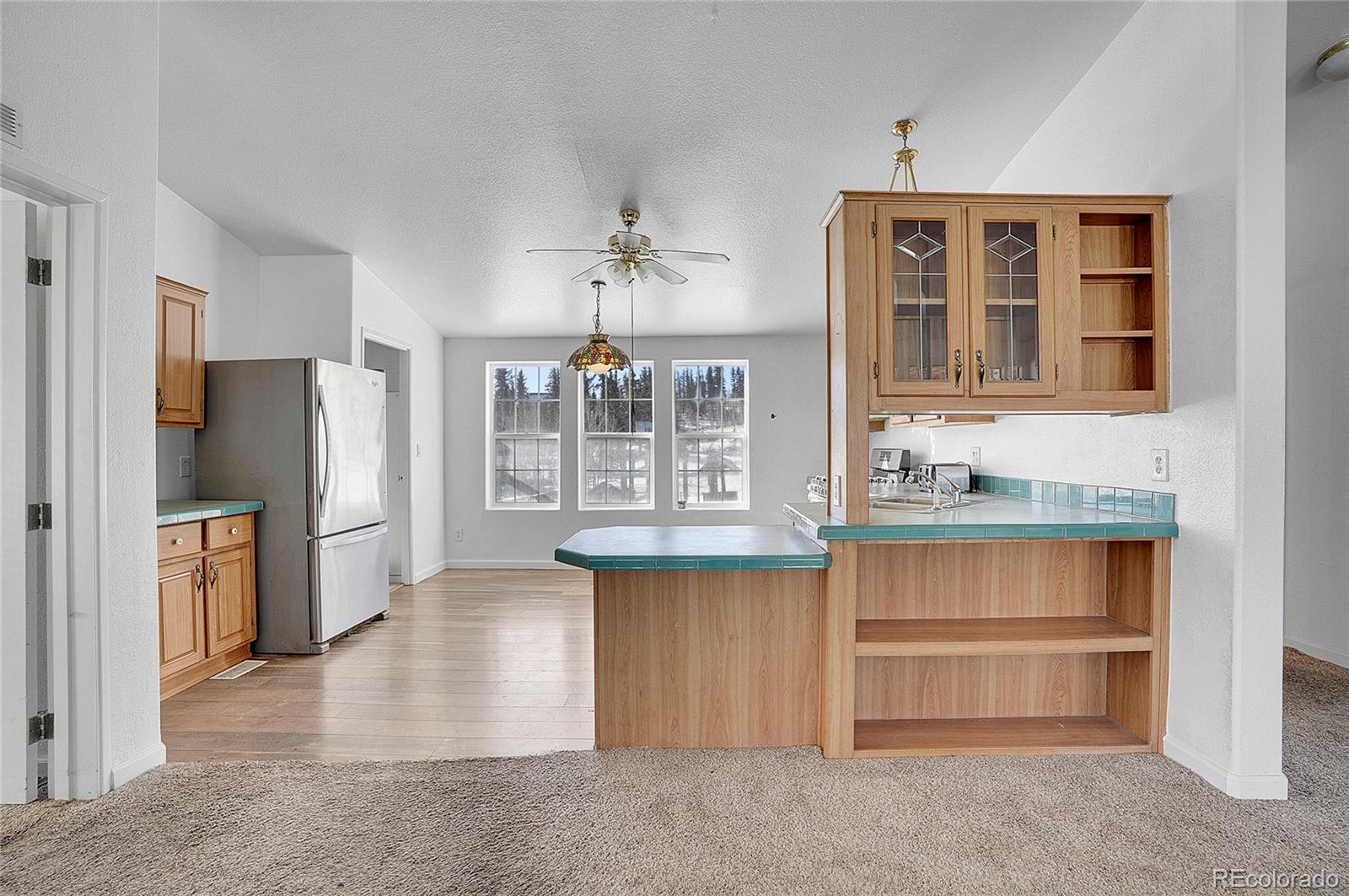 280 Apache Trail Jefferson, CO 80456 - Photo 9 of 50 a kitchen with stainless steel appliances granite countertop a refrigerator and a stove top oven
