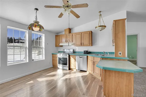 a kitchen with stainless steel appliances granite countertop a stove oven and a sink with cabinets