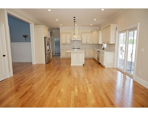 329 Brook Street Framingham, MA 01701 - Photo 15 of 28 a open kitchen with white cabinets and wooden floor