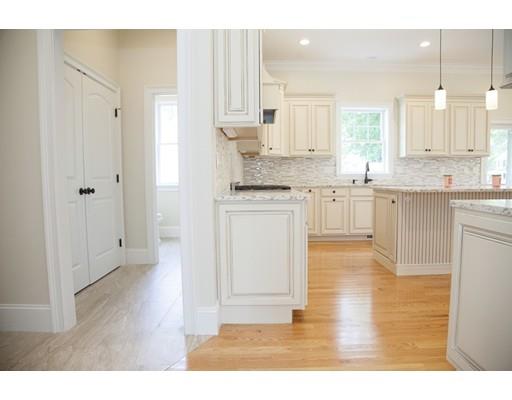 329 Brook Street Framingham, MA 01701 - Photo 16 of 28 a kitchen with stainless steel appliances granite countertop a stove a sink dishwasher and a refrigerator with wooden floor