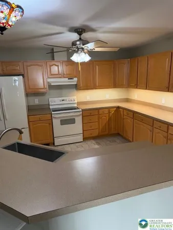 a kitchen with kitchen island a sink stainless steel appliances and cabinets