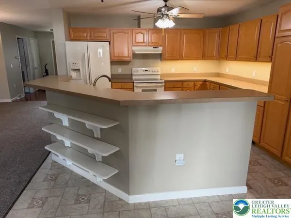 a kitchen with stainless steel appliances a refrigerator and cabinets