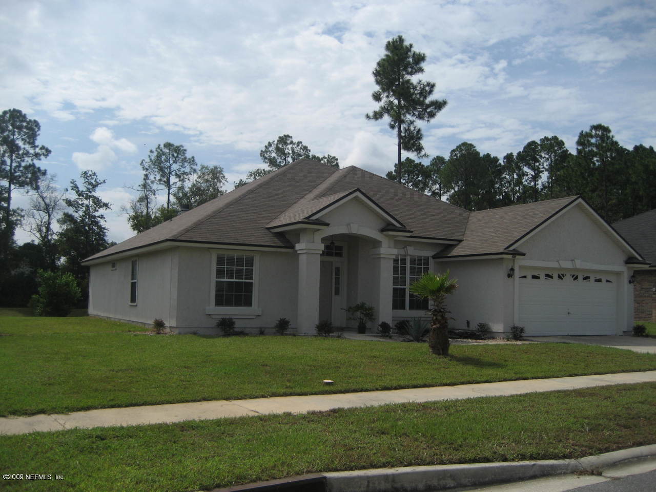 2933 Turning Leaf Lane Jacksonville, FL 32221 - Photo 1 of 15 a front view of a house with a garden