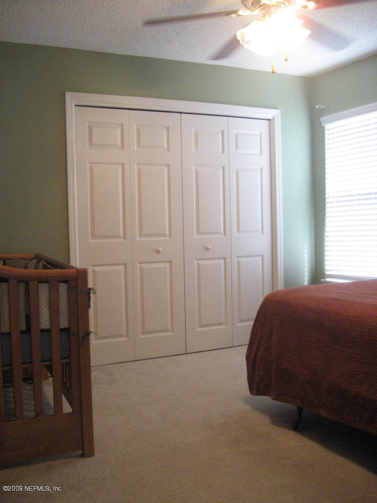 2933 Turning Leaf Lane Jacksonville, FL 32221 - Photo 12 of 15 a bedroom with a bed and a window