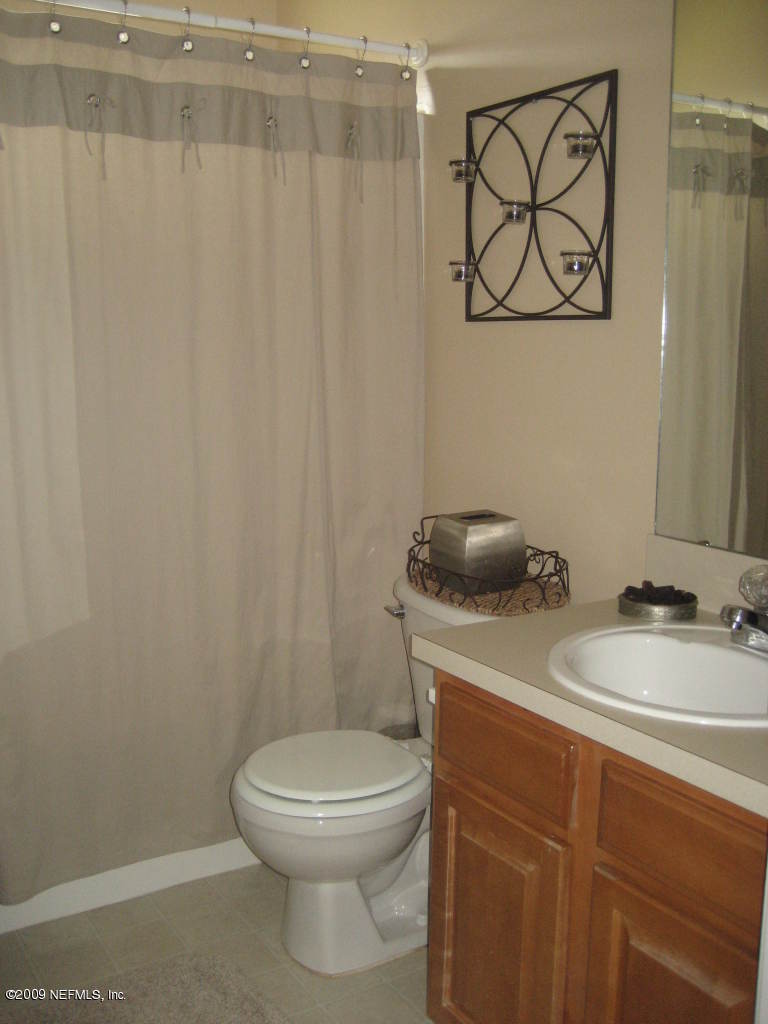 2933 Turning Leaf Lane Jacksonville, FL 32221 - Photo 13 of 15 a bathroom with a toilet sink and vanity
