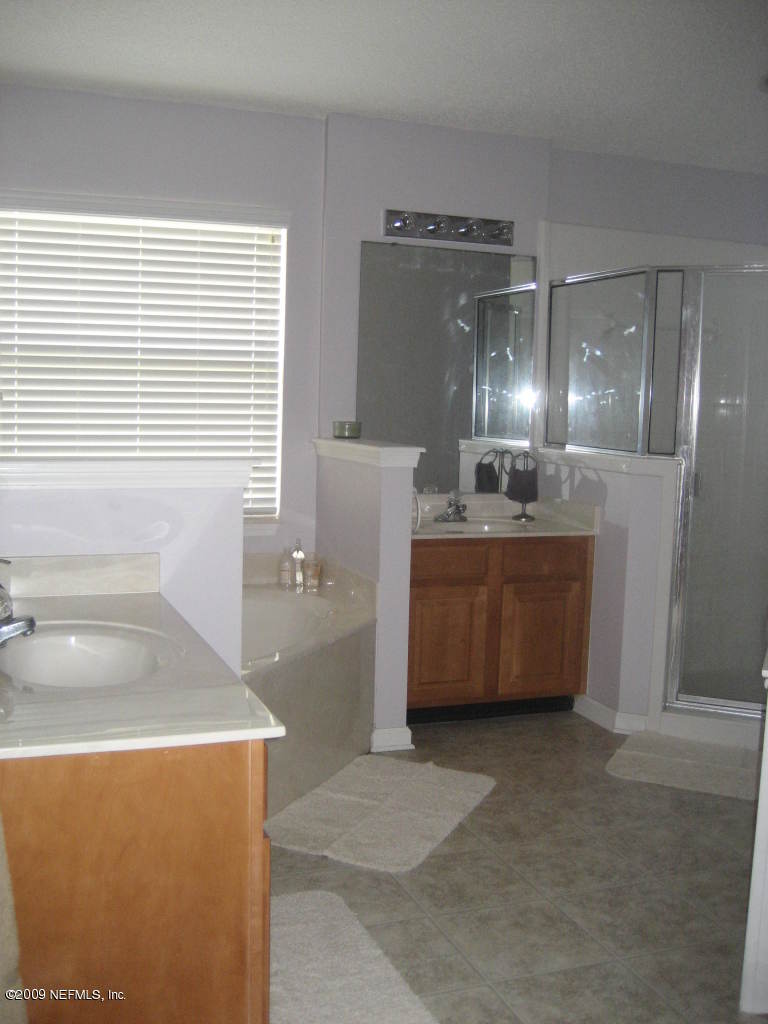 2933 Turning Leaf Lane Jacksonville, FL 32221 - Photo 9 of 15 a bathroom with a tub sink and mirror