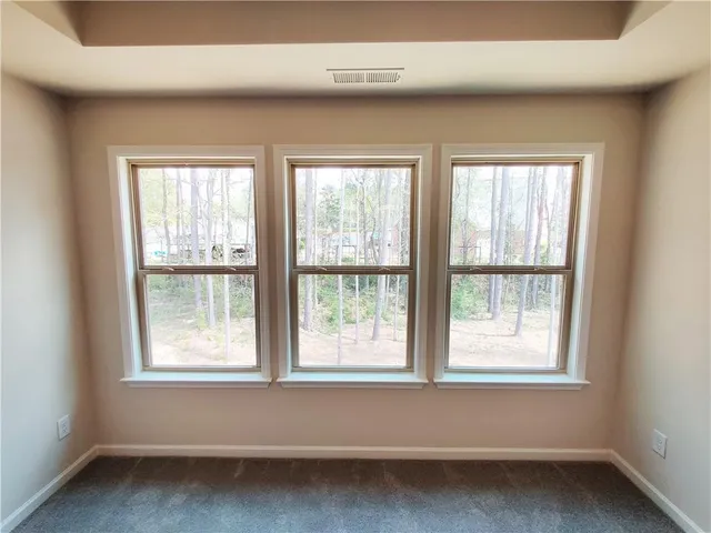 a view of a bathroom with mirror and window