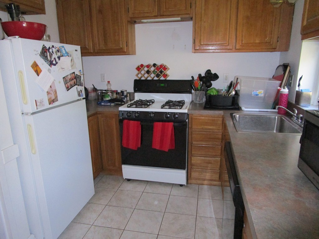 6 O'Leary Way, Unit 82 Boston, MA 02130 - Photo 7 of 14 a kitchen with stainless steel appliances granite countertop a refrigerator and a stove