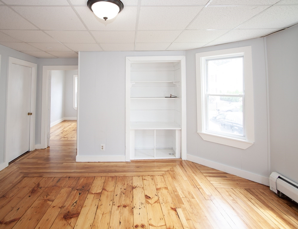 66 Cutler Street Worcester, MA 01604 - Photo 9 of 27 a view of empty room with wooden floor and fan