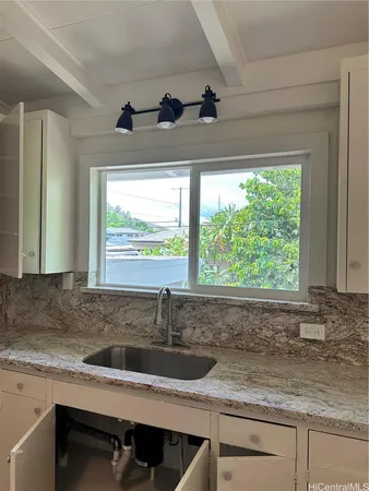 a kitchen with a sink and large window