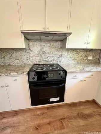 a stove top oven sitting inside of a kitchen