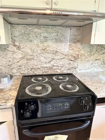 a stove top oven sitting inside of a kitchen