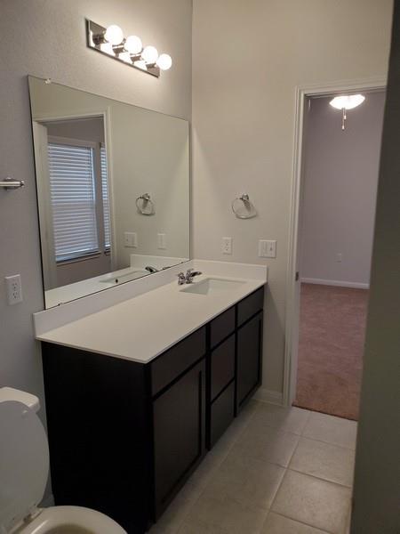 6404 Gunflint Drive Austin, TX 78747 - Photo 16 of 21 A well-appointed bathroom offers a dual sink vanity with ample counter space and cabinet storage.