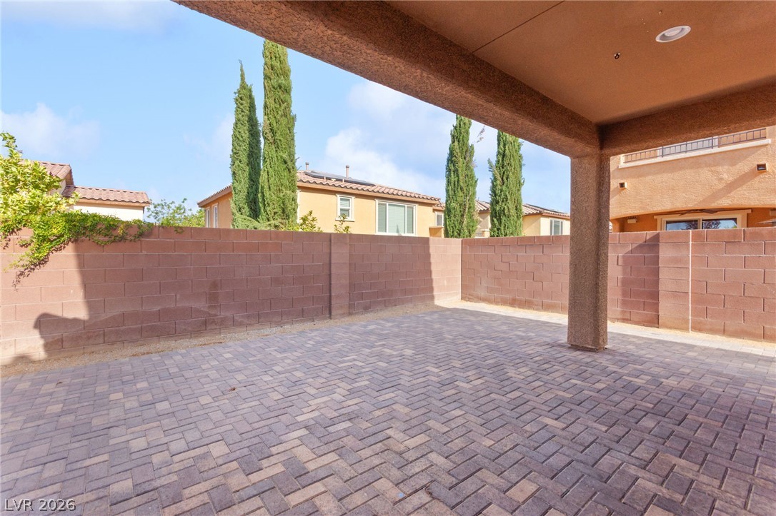 11048 Prairie Grove Road Las Vegas, NV 89179 - Photo 65 of 75 A spacious covered patio features herringbone pavers, ideal for outdoor entertaining.