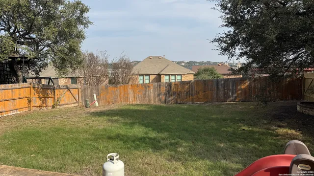a backyard of a house with lots of green space and garden