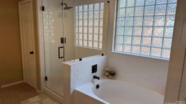a bathroom with a tub and shower