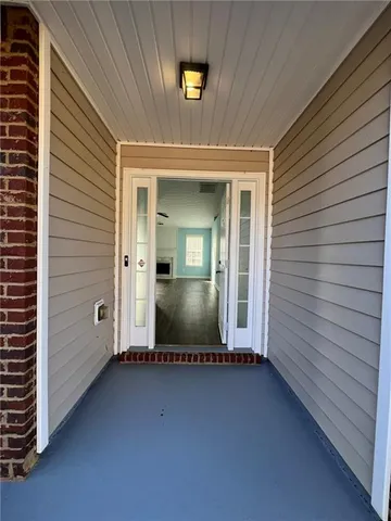 a view of empty room with wooden floor and fireplace